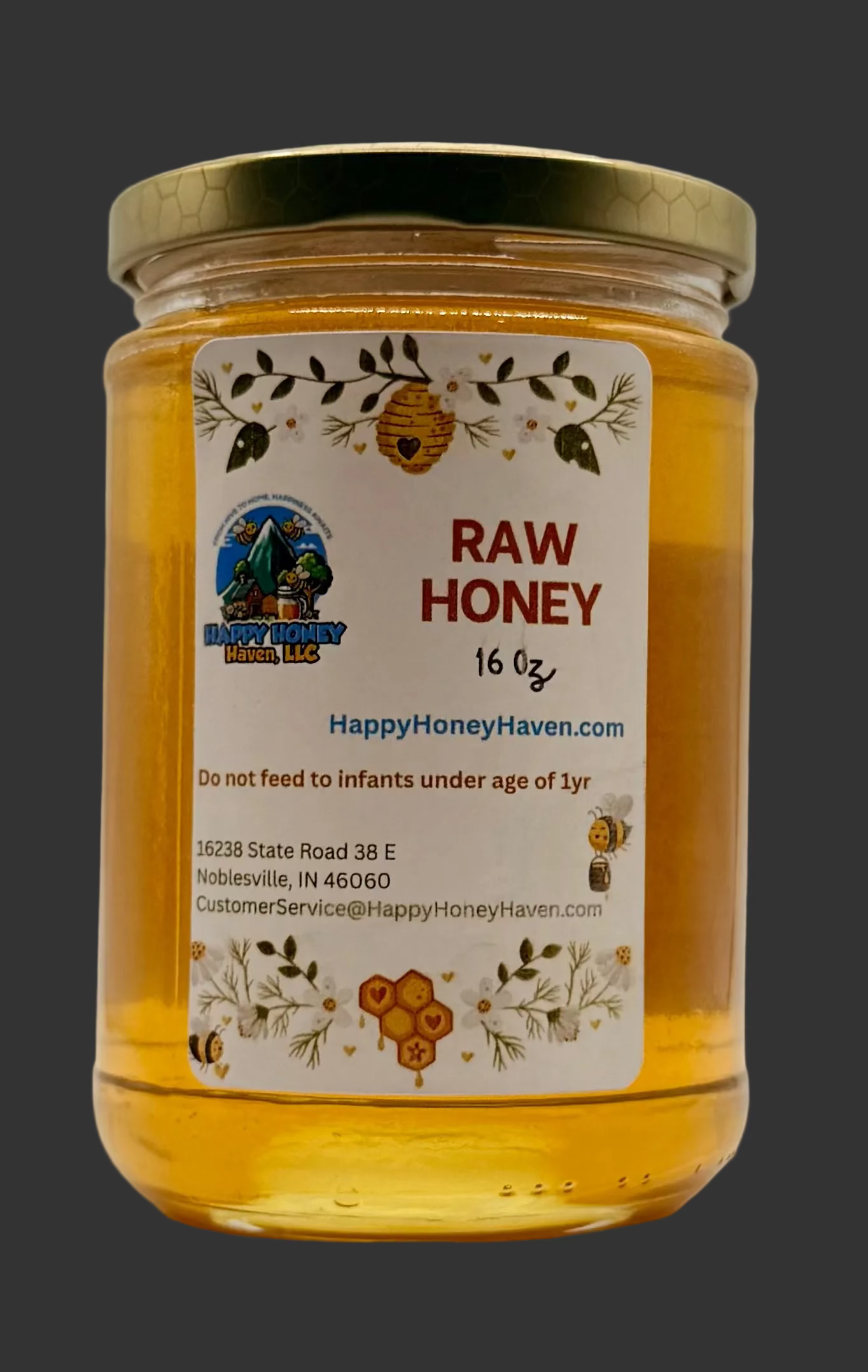 A 16 oz glass jar of raw honey with a gold metal lid and a white label featuring bee illustrations and the Happy Honey Haven logo, set against a plain white background.